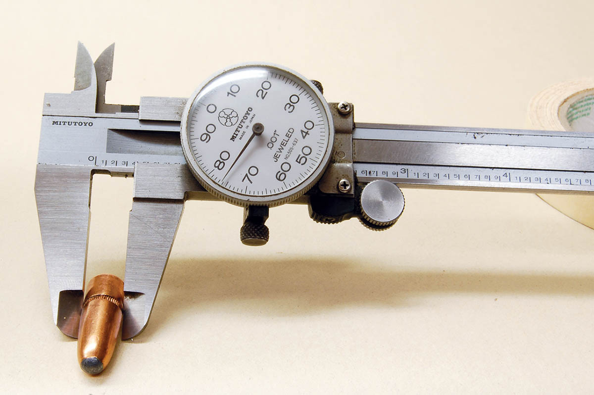 A caliper on a 9.5mm bullet showing .376-inch diameter.